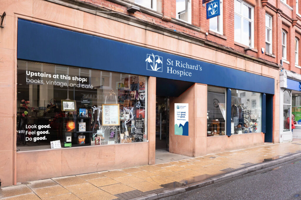 Front of St Richard’s Hospice charity shop with blue signage and large windows on a high street.