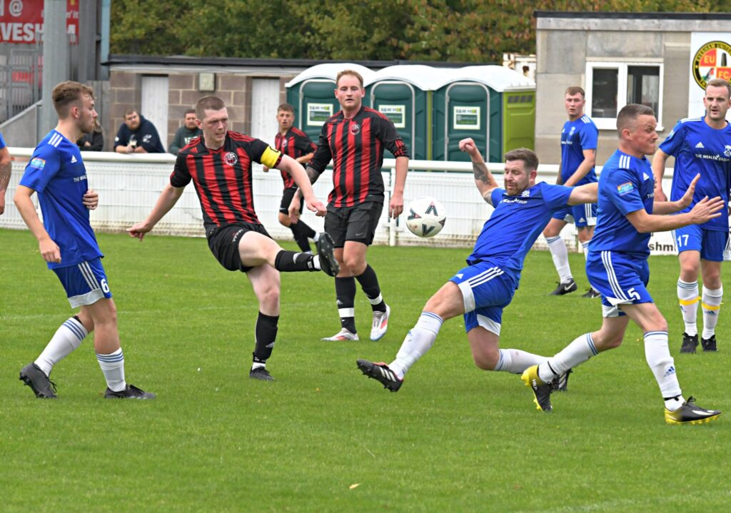 The Evesham branches of Tesco (in red and black) and Morrisons (in blue) play each other in their annual Retail Challenge Cup